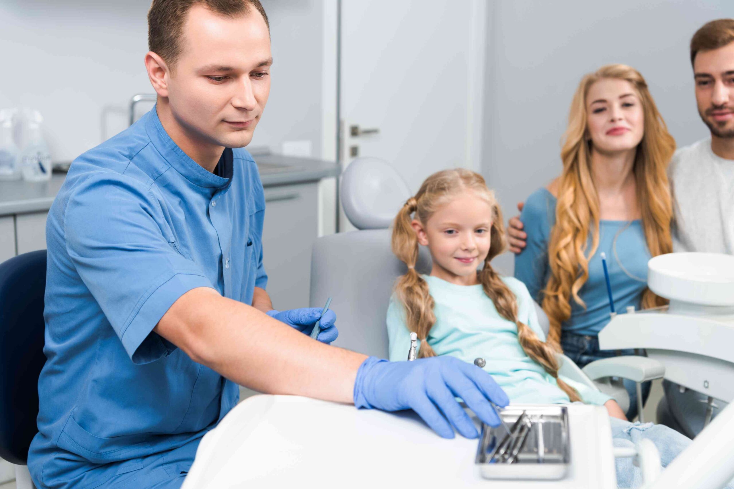 Girl attending a dental clinic with her family