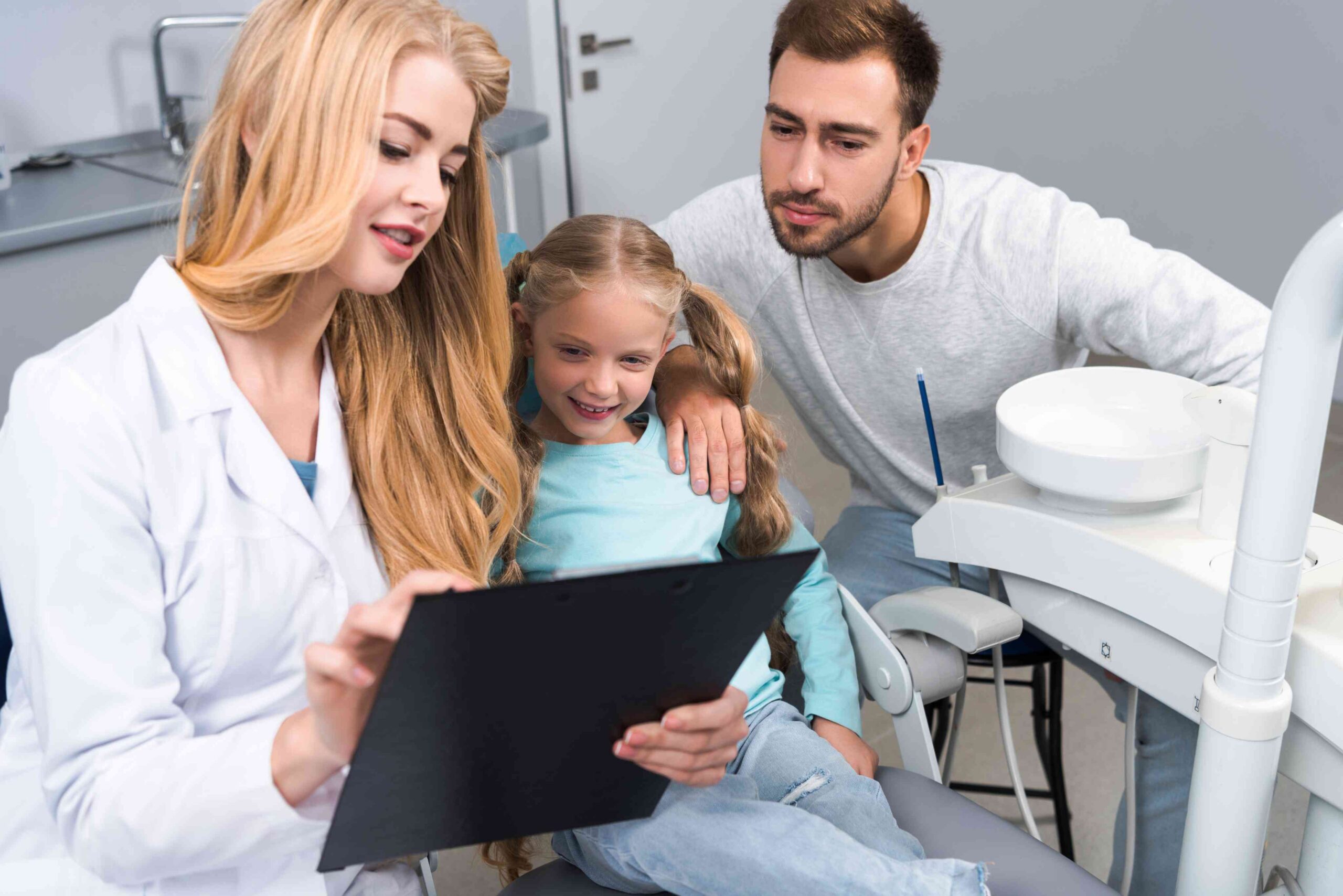 Father and child attending a routine dental examination