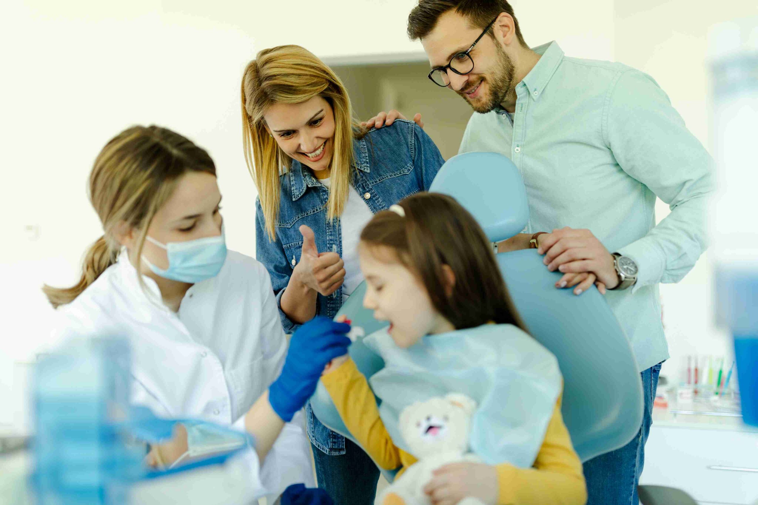 Girl attending a dental clinic with her family for oral healthcare.