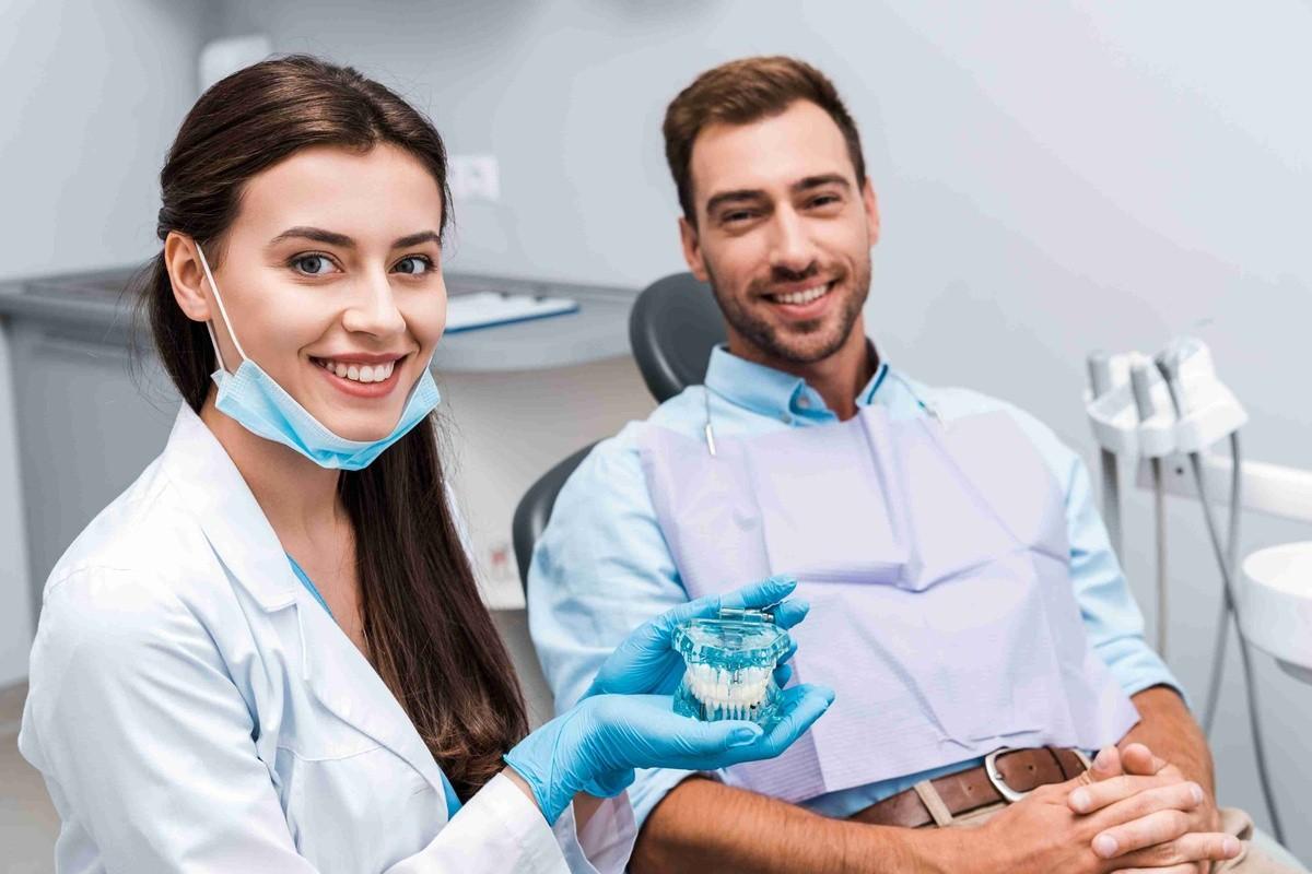 Pediatric dentist explaining sedation options to a child and parent